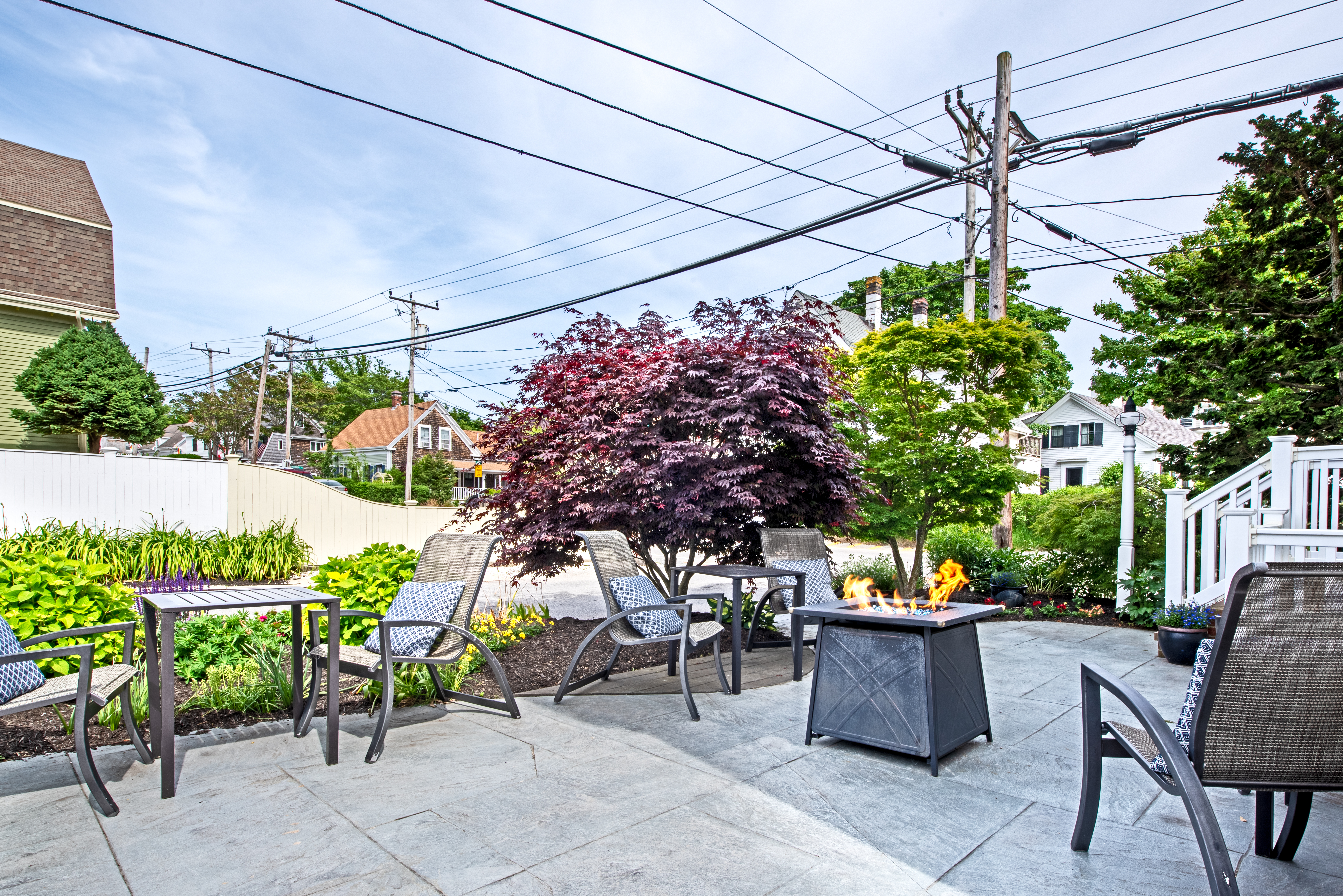 A patio with outdoor furniture and a fire pit