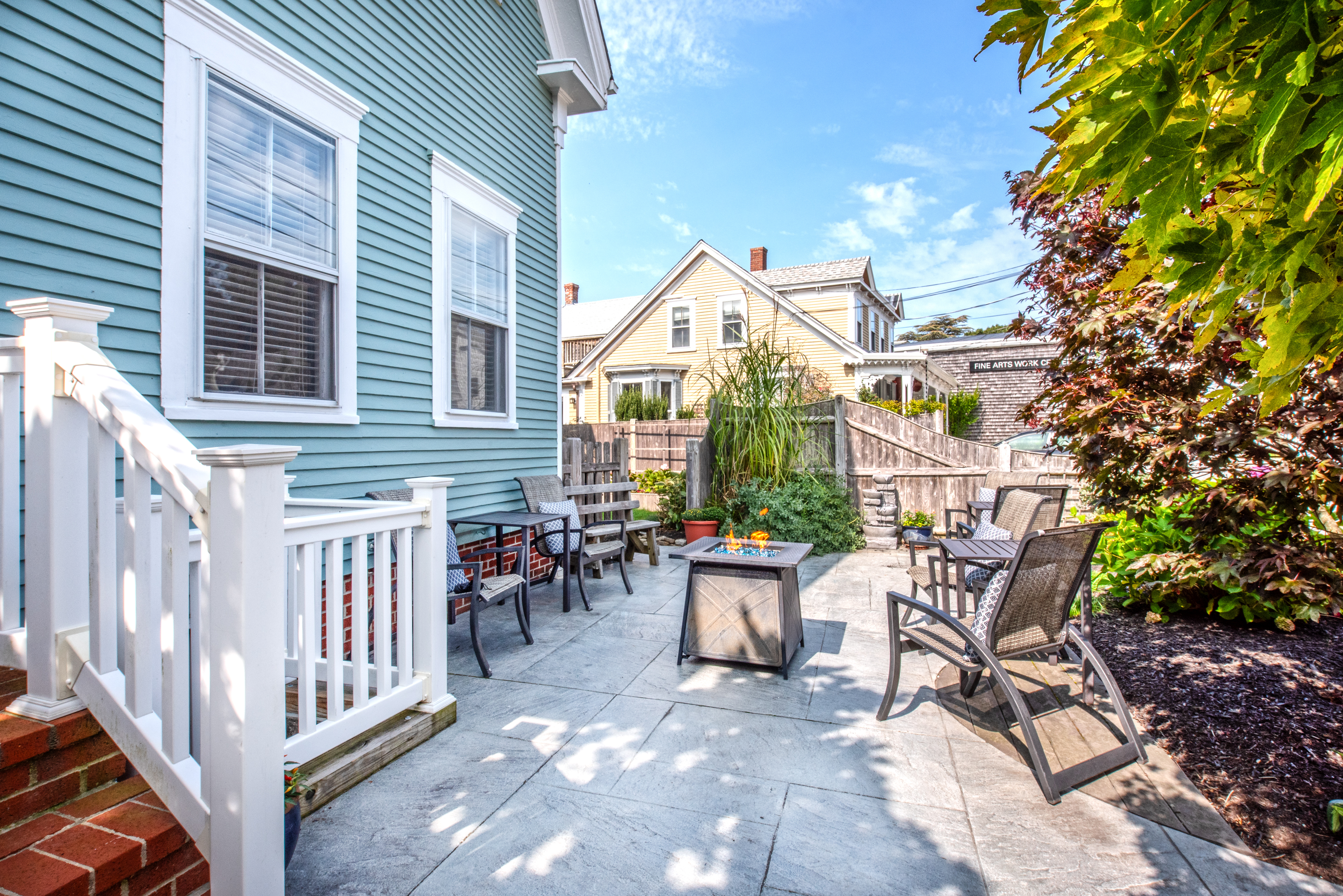 A patio area with outdoor furniture and a fire table